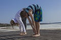 mother and son doing stretching exercises on the beach Royalty Free Stock Photo