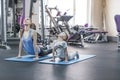 Mother and son doing yoga exercise at gym