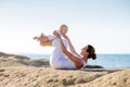 A mother and a son are doing yoga exercises at the seashore of M Royalty Free Stock Photo