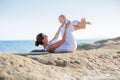 A mother and a son are doing yoga exercises at the seashore of M Royalty Free Stock Photo