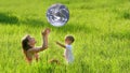 Mother and son with earth-like ball Royalty Free Stock Photo