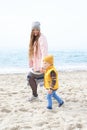 Mother and son enjoying the walk by the sea