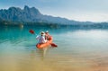 Mother and son floating on kayak together on Cheow Lan lake in Thailand. Traveling with kids concept image Royalty Free Stock Photo