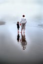 Mother and Son on Foggy Beach with Red Bucket Pail Royalty Free Stock Photo