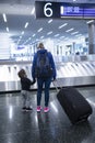 Mother and son going on holiday, wearing face masks at the airport. Royalty Free Stock Photo