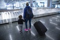 Mother and son going on holiday, wearing face masks at the airport. Royalty Free Stock Photo