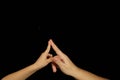 Mother and son hands, touch with index fingers. Isolated women and children palms on a black background. The concept of family rel