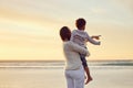 Mother and son having fun at the beach. Woman pointing at sky while watching the view by the sea with her son. Spending Royalty Free Stock Photo