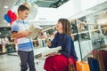 Mother and son having fun in shopping mall toghether