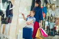 Mother and son having fun in shopping mall toghether