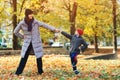 Mother and son having fun together in autumn park. Happy family on walk. Autumn vacations Royalty Free Stock Photo