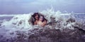 Mother and Son Hit by Wave Royalty Free Stock Photo