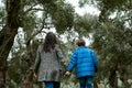 Mother and son holding hands walking in a park Royalty Free Stock Photo