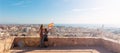 Mother and son holding Spain flag and looking at Almeria city