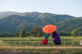 A mother and son holding umbrella and playing outdoors at sunset Royalty Free Stock Photo