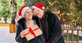 Mother and son hugging each other holding christmas gift at park Royalty Free Stock Photo