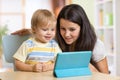 Mother and son kid playing with tablet computer Royalty Free Stock Photo