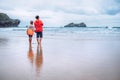 Mother and son look on waves on ocean coast line after the storm Royalty Free Stock Photo