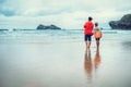 Mother and son look on waves on ocean coast line after the storm Royalty Free Stock Photo