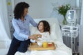 Mother and son looking at each other in the ward at hospital