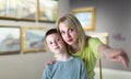 Mother and son looking at paintings in halls of museum Royalty Free Stock Photo