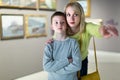 Mother and son looking at paintings in halls of museum Royalty Free Stock Photo