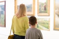 Mother and son looking at paintings in halls of museum Royalty Free Stock Photo