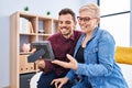 Mother and son looking photo sitting on bed at bedroom Royalty Free Stock Photo