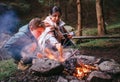 Mother with son make campfire