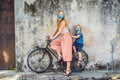 Mother and son in medical mask on a bicycle. Public street art Name Children on a bicycle painted 3D on the wall that`s Royalty Free Stock Photo