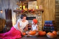 Mother and son in orange cap with pumpkins are Royalty Free Stock Photo