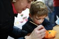 Mother with son painting stuffed toy Royalty Free Stock Photo