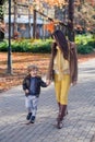 Mother and son in park walking and communicating. Royalty Free Stock Photo