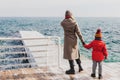 Mother and son on a pier at the sea in winter Royalty Free Stock Photo