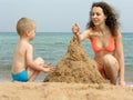 Mother with son play on beach Royalty Free Stock Photo