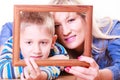 Mother and son play with empty frame.