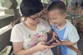 Mother and son play smartphone