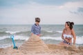 Mother and son playing on the beach at the sunset time. Concept of friendly family Royalty Free Stock Photo