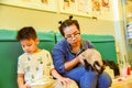 Mother with son playing cat at home  in living room interior,Kids and pets. Beautiful feline cat at home Royalty Free Stock Photo