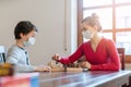 Mother and son playing chess to kill some time during curfew in crises Royalty Free Stock Photo