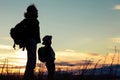 Mother and son playing on the coast of lake of at the sunset ti Royalty Free Stock Photo