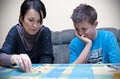 Mother and son playing dice Royalty Free Stock Photo
