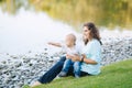 Mother and son playing near the lake Royalty Free Stock Photo