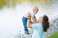 Mother and son playing near the lake Royalty Free Stock Photo