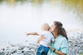 Mother and son playing near the lake Royalty Free Stock Photo