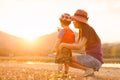A mother and son playing outdoors at sunset with love Royalty Free Stock Photo