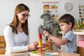 Mother and son Playing together with colorful didactic toys