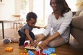 Mother And Son Playing With Toys On Floor At Home Royalty Free Stock Photo