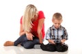 Mother and son playing video game on smart phone Royalty Free Stock Photo