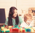 Mother and son in playroom on light wooden background. Royalty Free Stock Photo